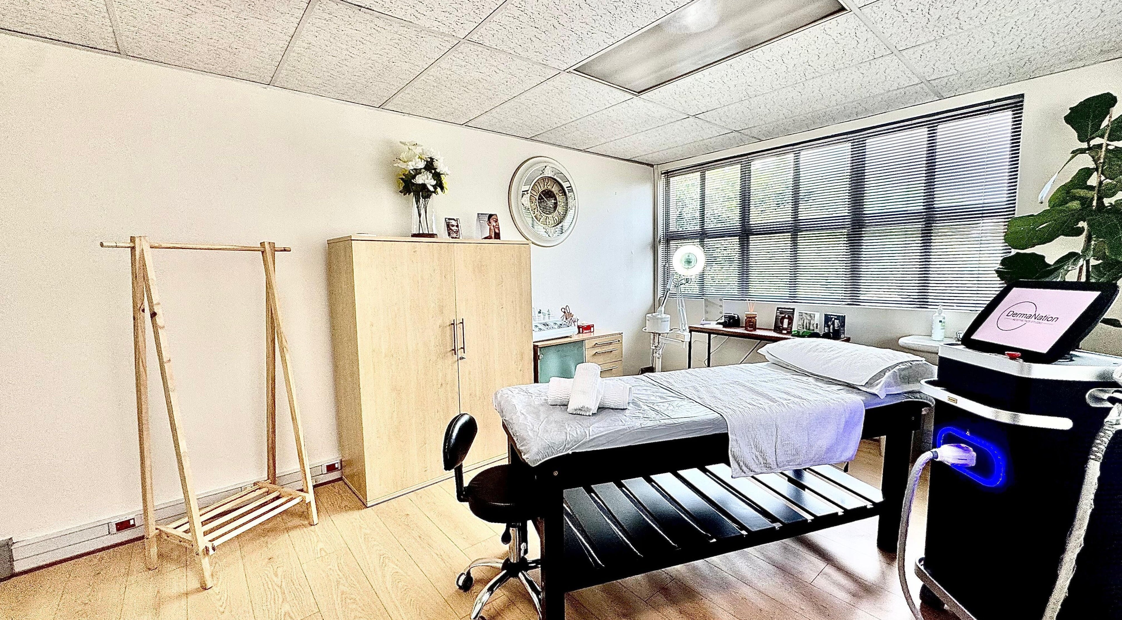 Spa room at Dermanation South Africa, Sandton, Gauteng, ZA. Includes massage table and modern equipment.