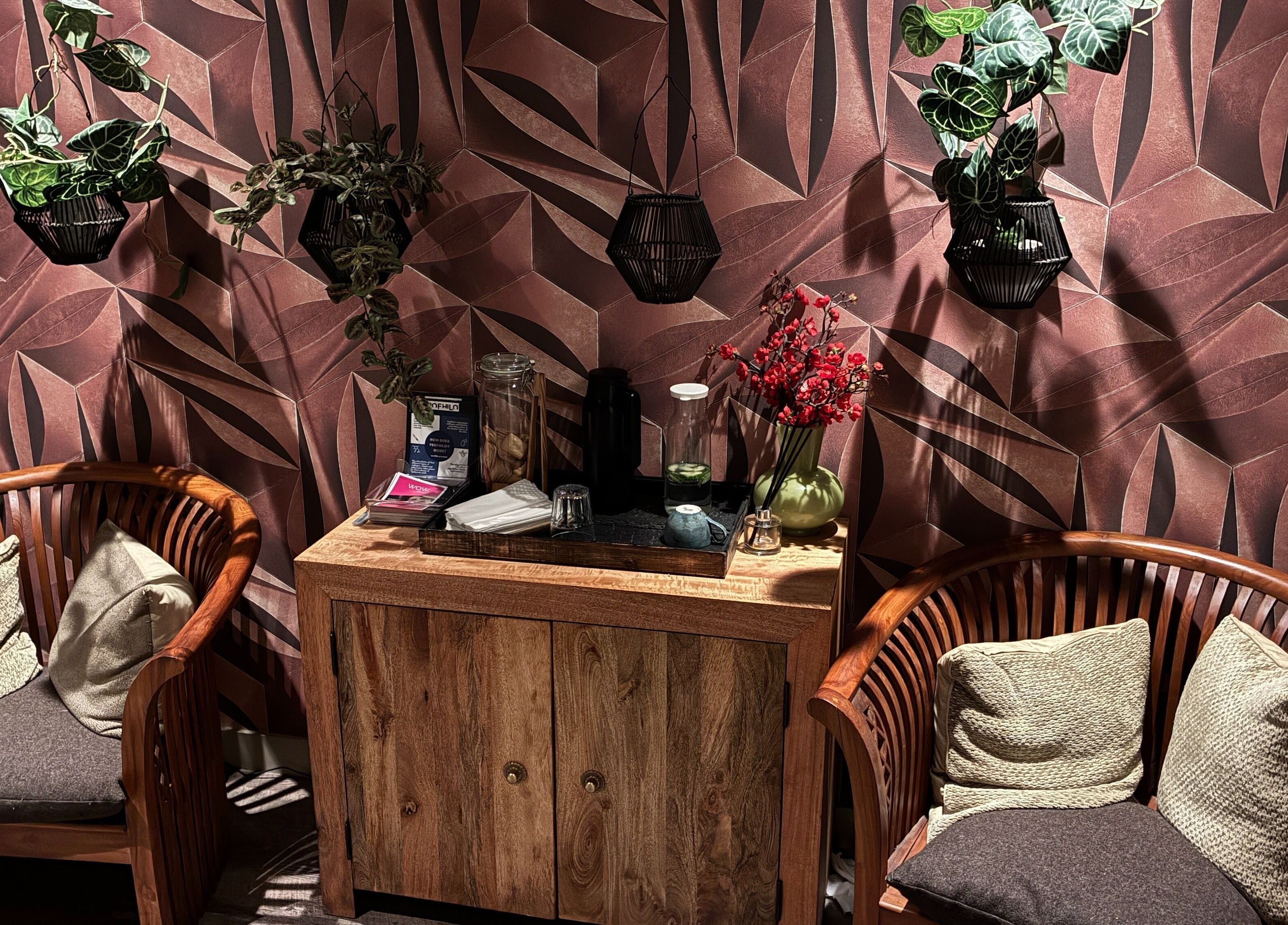 Cozy seating area at Reflexology Wimbledon at Gina Conway, London, England, GB with lush decor and soft lighting.