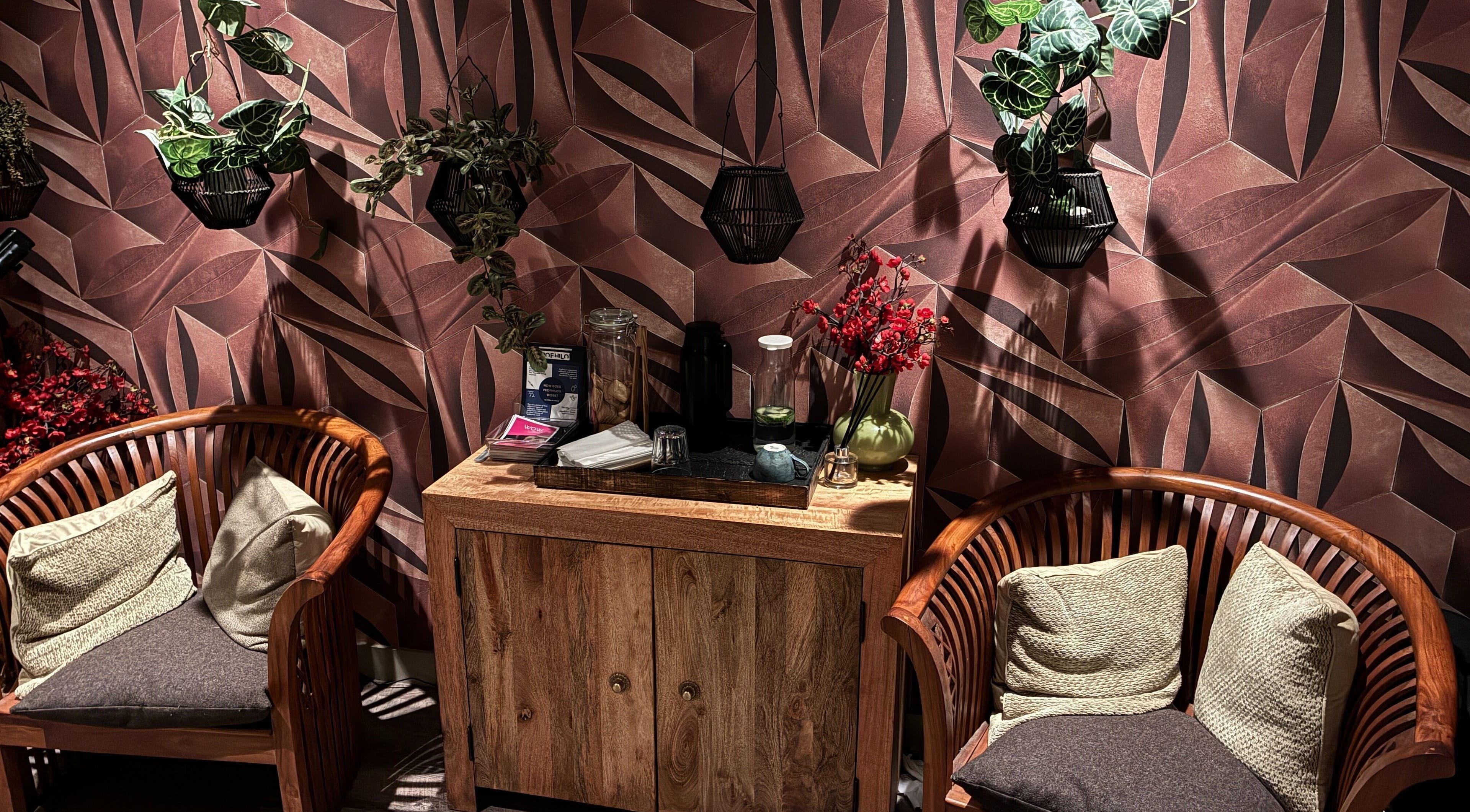Cozy seating area at Reflexology Wimbledon at Gina Conway, London, England, GB with lush decor and soft lighting.