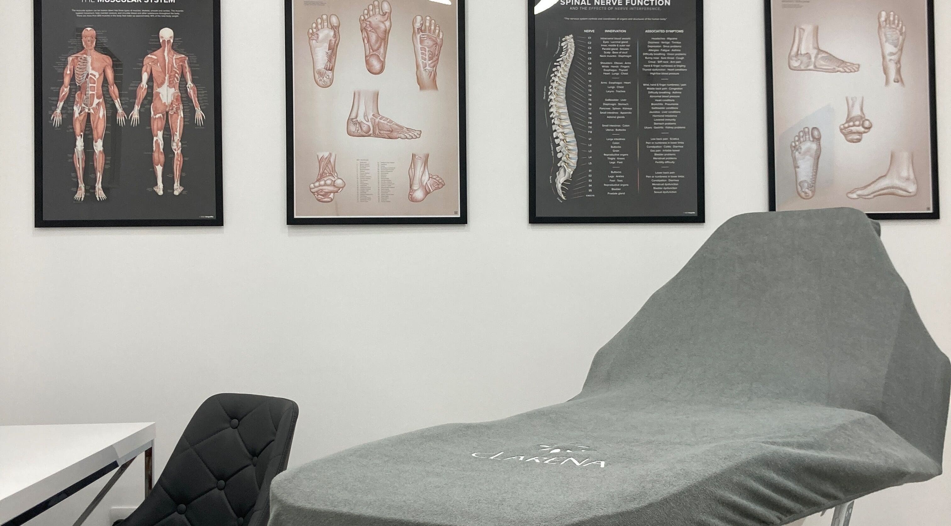 Reflexology Wimbledon massage chair and anatomical charts in London, England, GB wellness center.