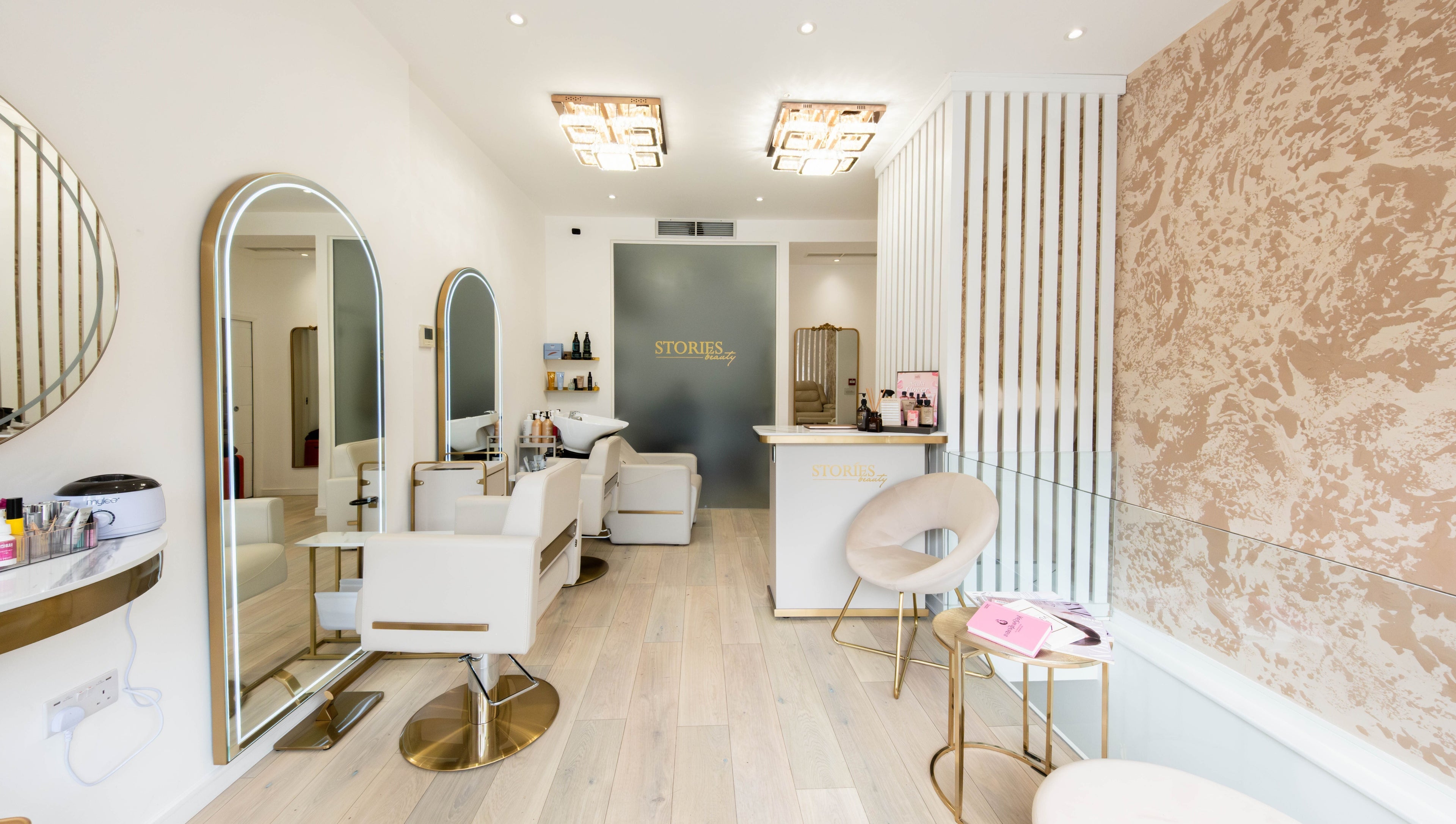 Elegant interior of Beauty Stories Fulham salon in London, England, GB featuring stylish chairs and decor.