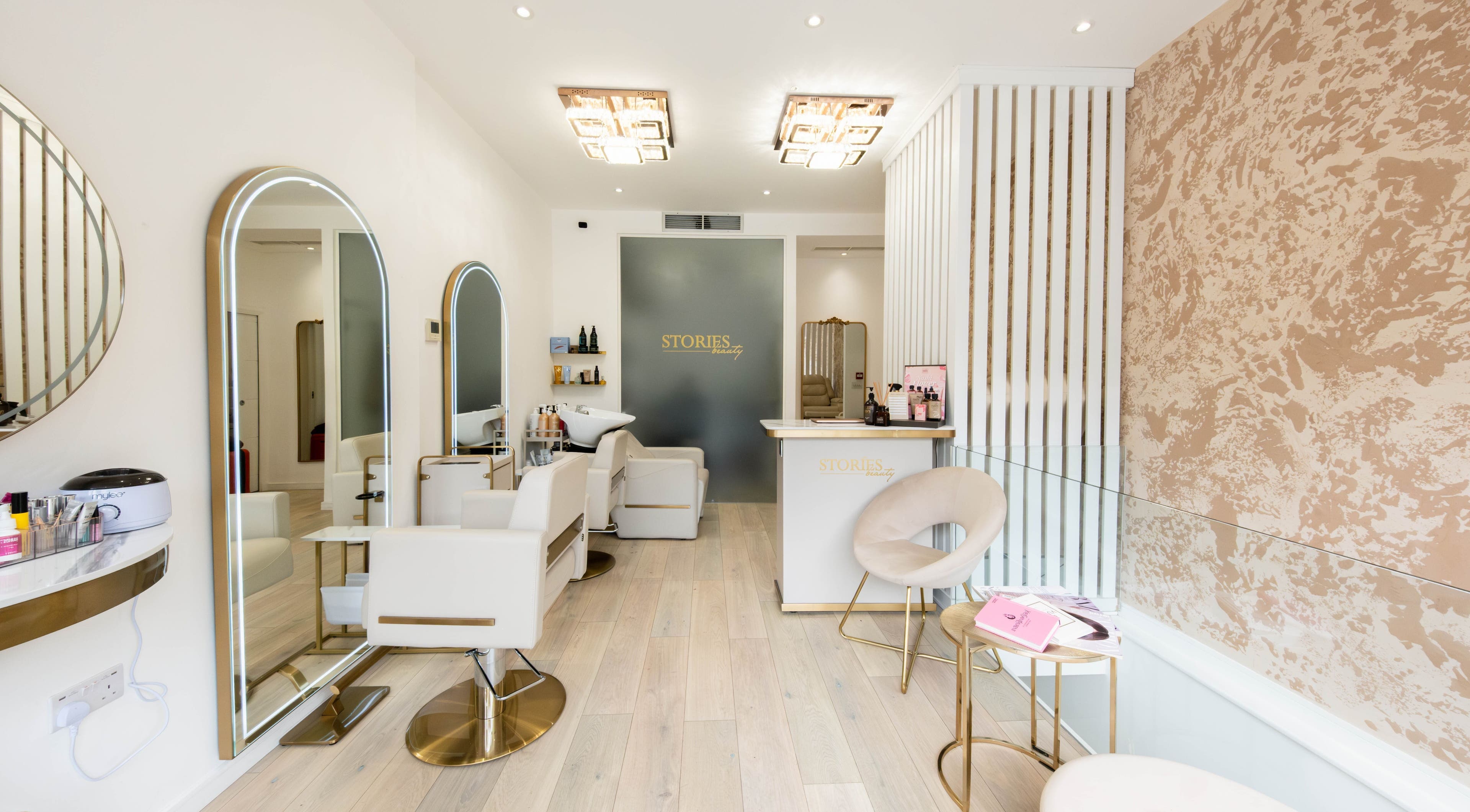Elegant interior of Beauty Stories Fulham salon in London, England, GB featuring stylish chairs and decor.