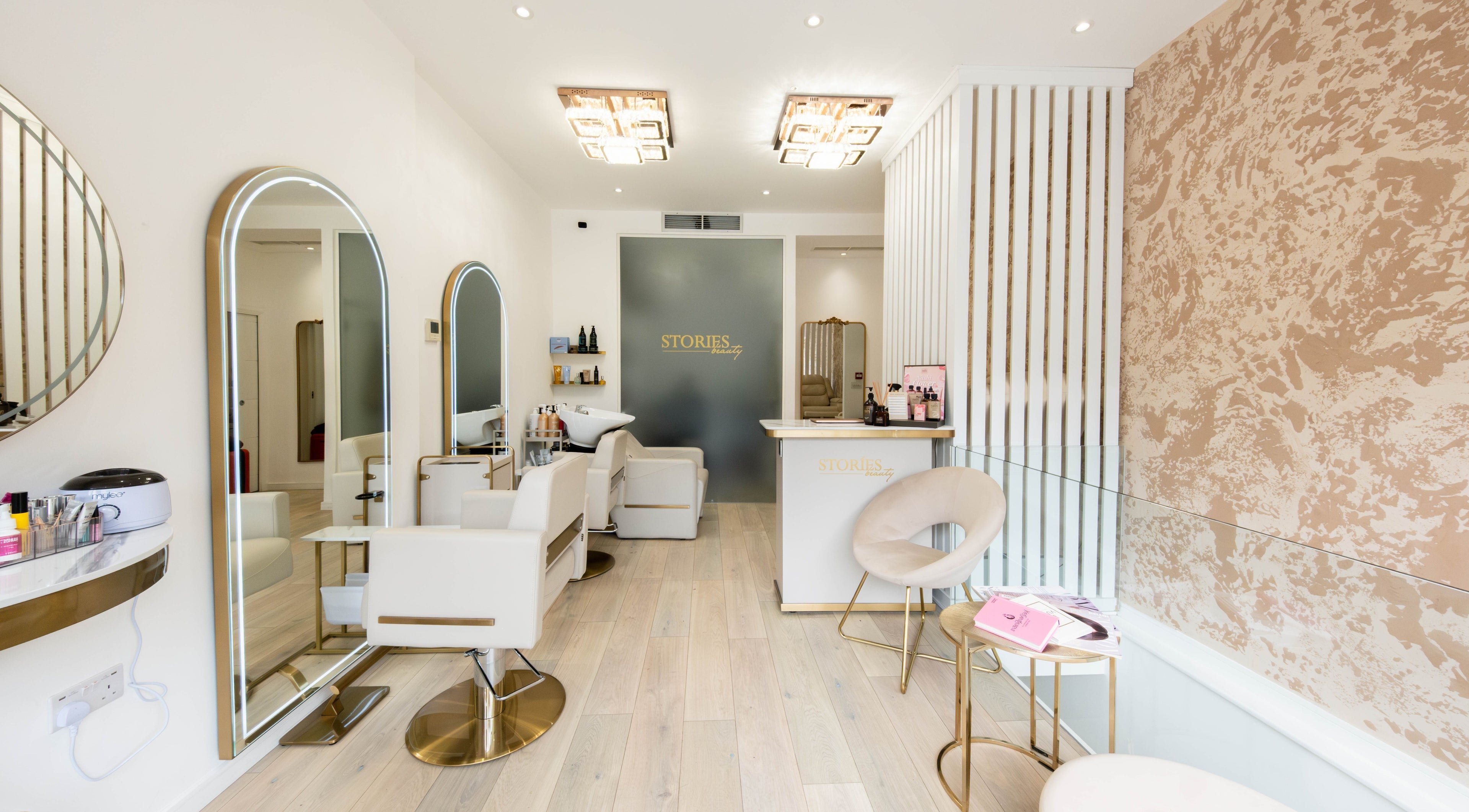 Elegant interior of Beauty Stories Fulham salon in London, England, GB featuring stylish chairs and decor.