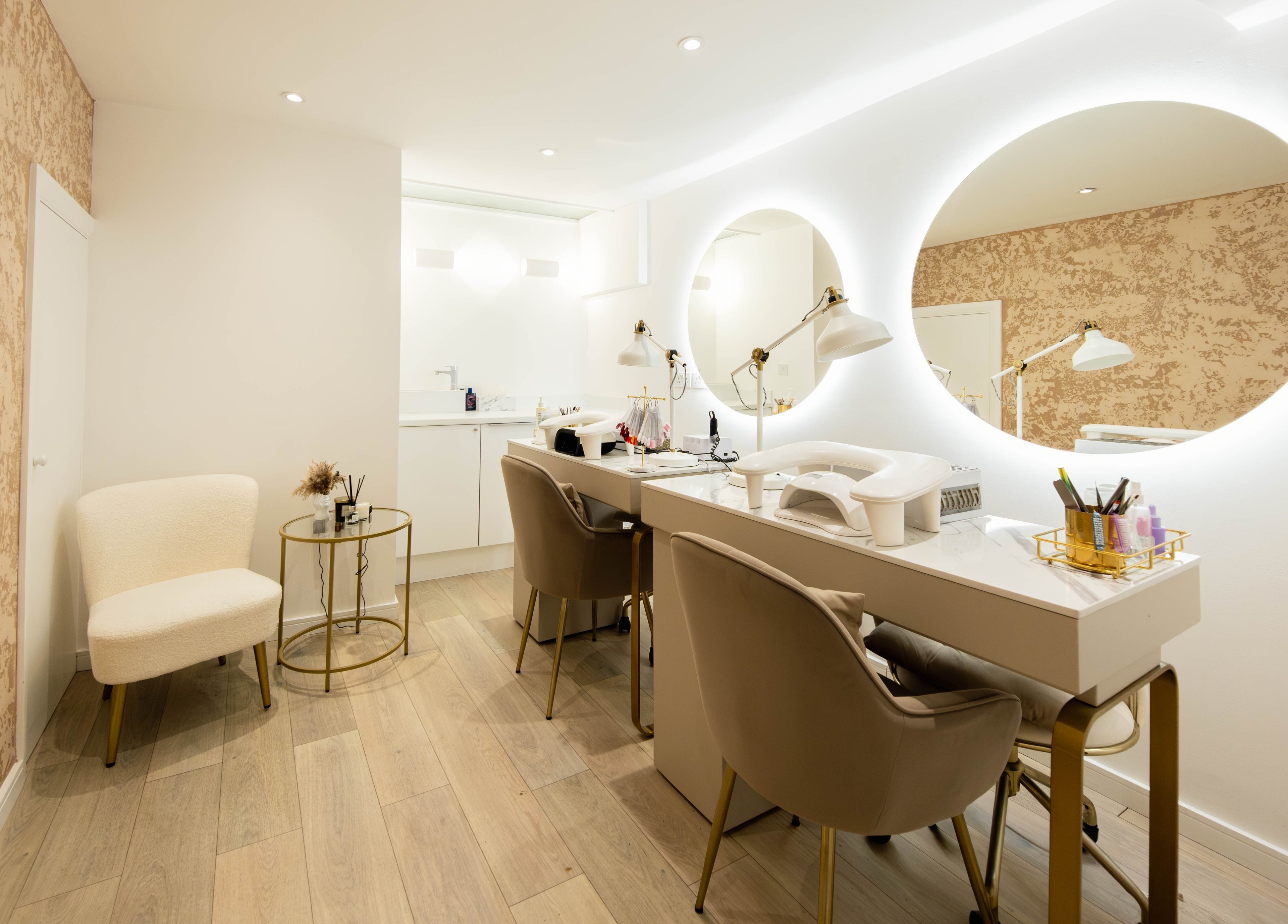 Elegant beauty station at Beauty Stories Fulham, London, England, GB with plush chairs and lighted mirrors.