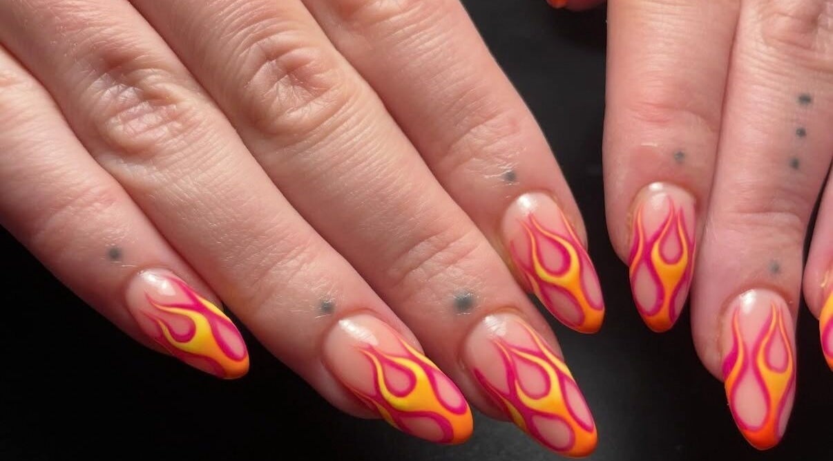Fiery nail art at Lady Luck Nails Worthing, West Sussex, GB. Intricate flame design on natural nails.