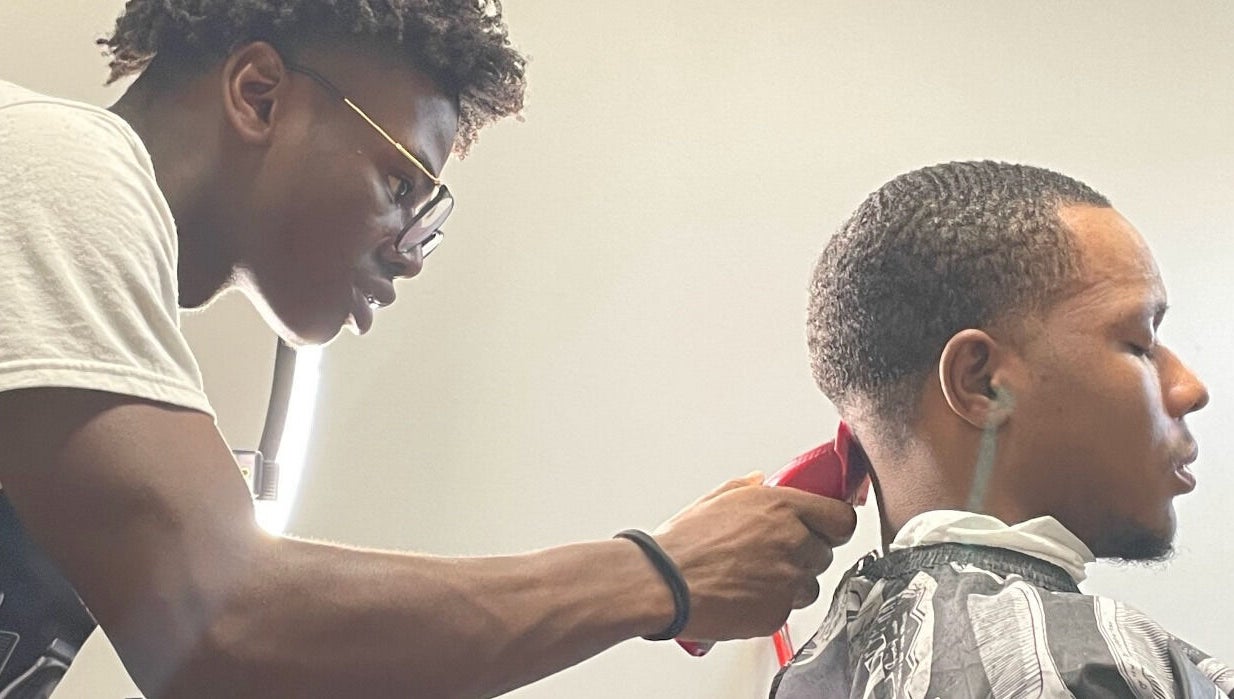 Barber crafting a precise haircut at Jesus in da Cut ™️, Berrien Springs, Michigan, US.