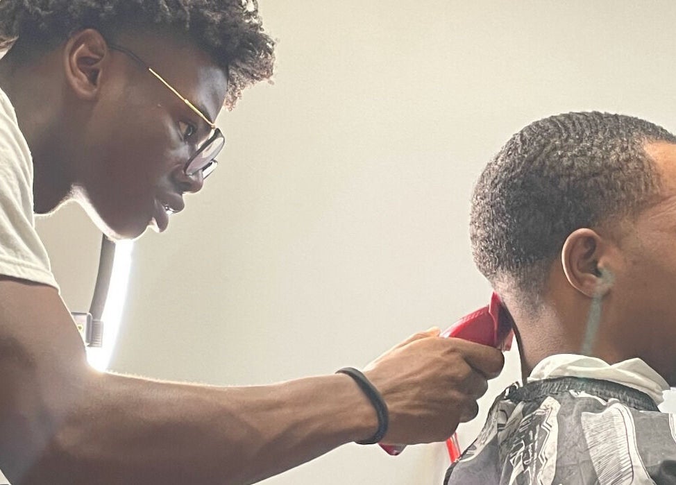 Barber crafting a precise haircut at Jesus in da Cut ™️, Berrien Springs, Michigan, US.