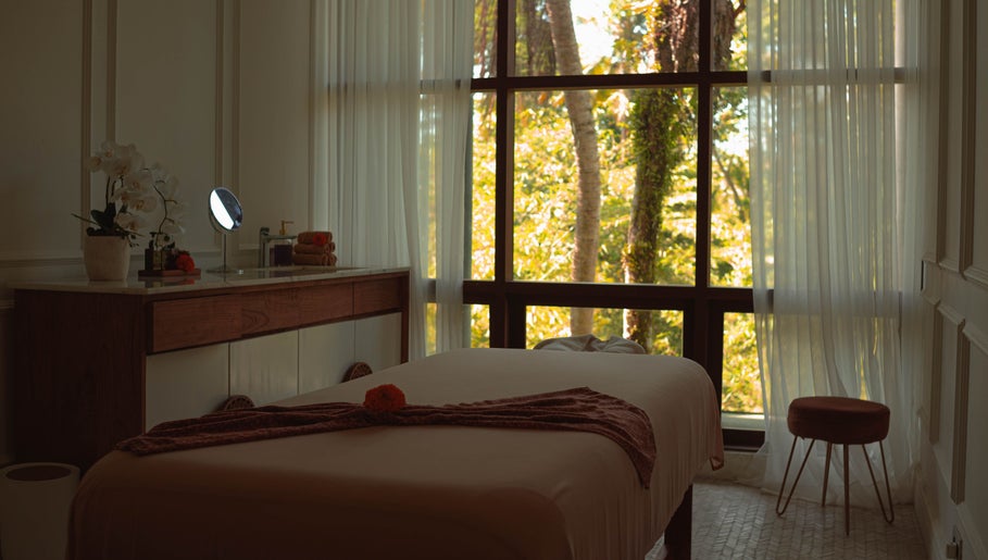 Relaxing treatment room at Hutan Spa, Bali, Bali, ID, with a massage table and greenery view.