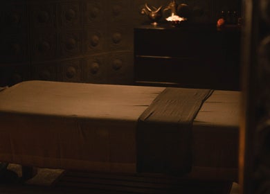 Serene spa massage room at Hutan Spa, Bali, Bali, ID with dim lighting and a comfortable massage table.