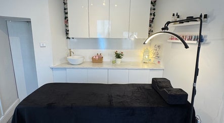 Relaxing treatment room at Infinity Brows in Poole, England, GB, featuring a sleek massage table and modern decor.