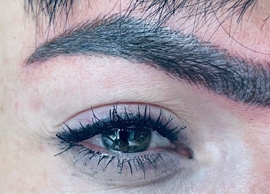 Close-up of expertly shaped eyebrows at Infinity Brows, Poole, England, GB, showcasing detailed microblading work.