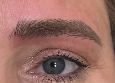 Close-up of expertly shaped eyebrow by Infinity Brows in Poole, England, GB showcasing precise grooming.