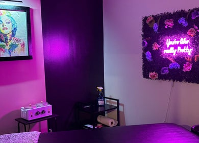 The Modern Beauty Lounge, LLC in Inman, South Carolina offers a vibrant room with neon lighting and art decor.