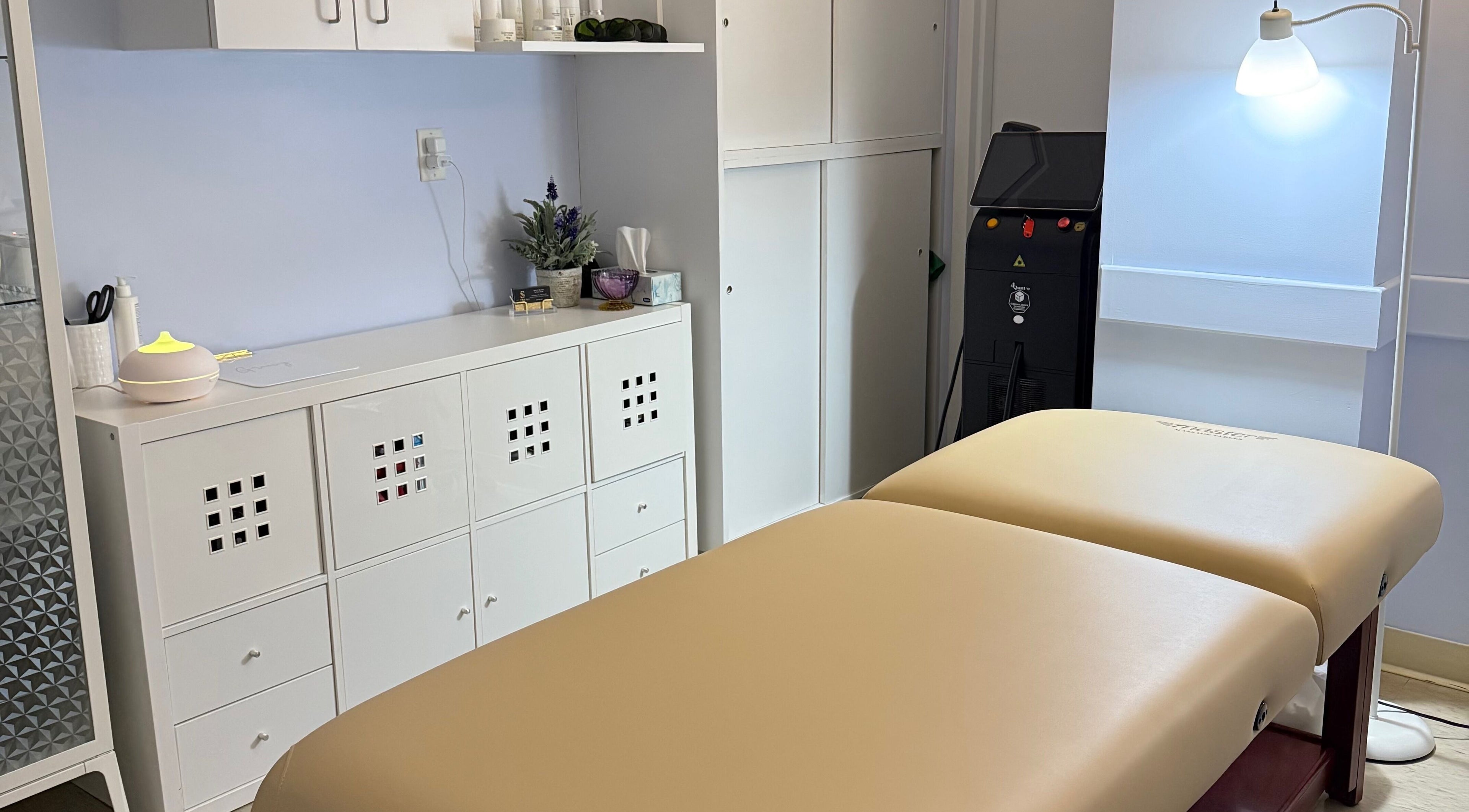 Calming treatment room at Laser & Skincare by Yana Koval, Moncton, Canada, CA featuring a massage table.