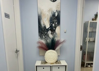 Stylish entrance at Laser & Skincare by Yana Koval, Moncton, Canada, CA, featuring chic decor and art piece.