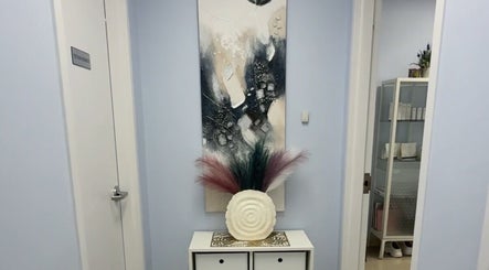 Stylish entrance at Laser & Skincare by Yana Koval, Moncton, Canada, CA, featuring chic decor and art piece.