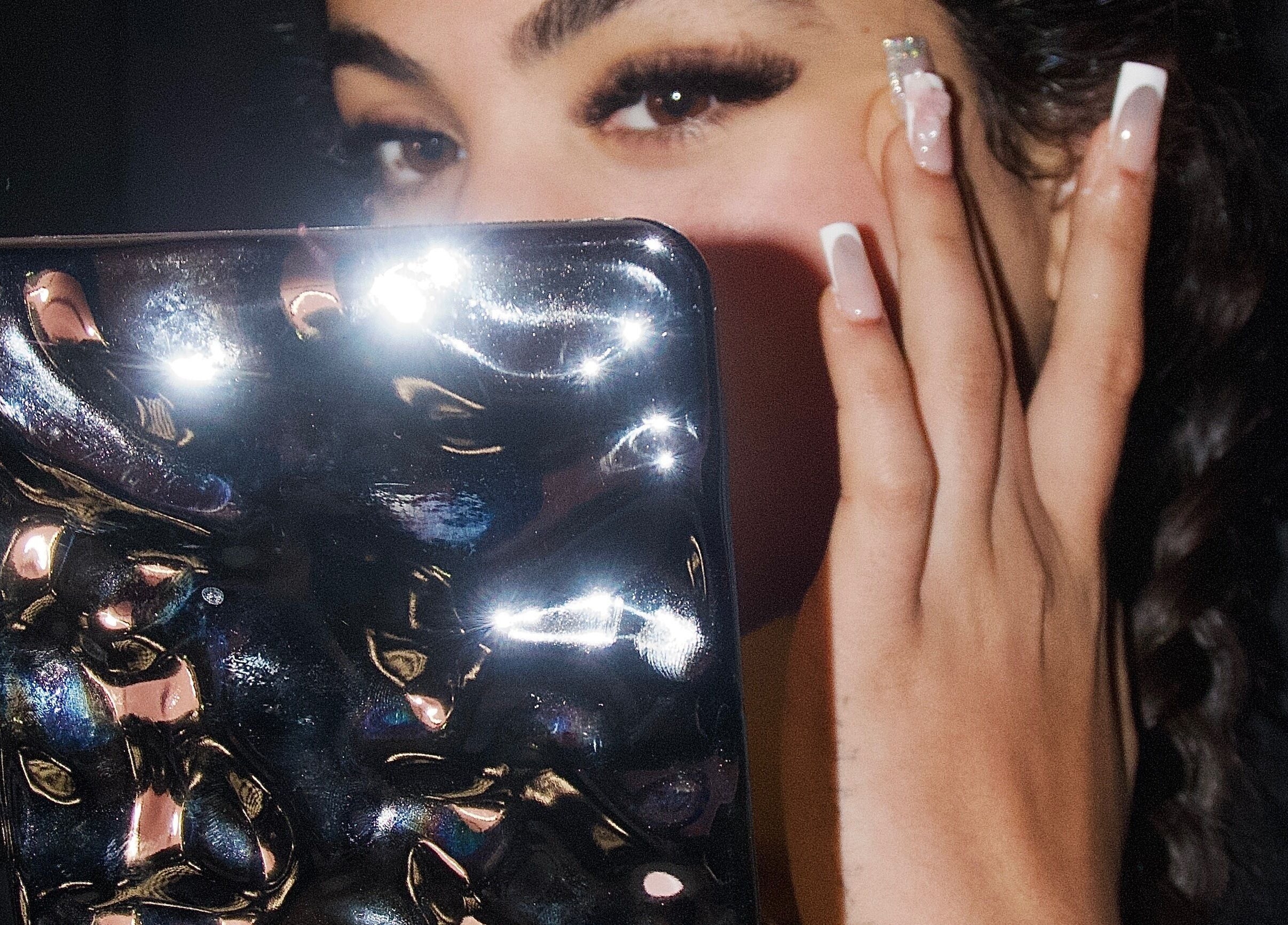 Woman with mirror and manicured nails at Ladylux de Beaute, Melbourne, Victoria, AU.