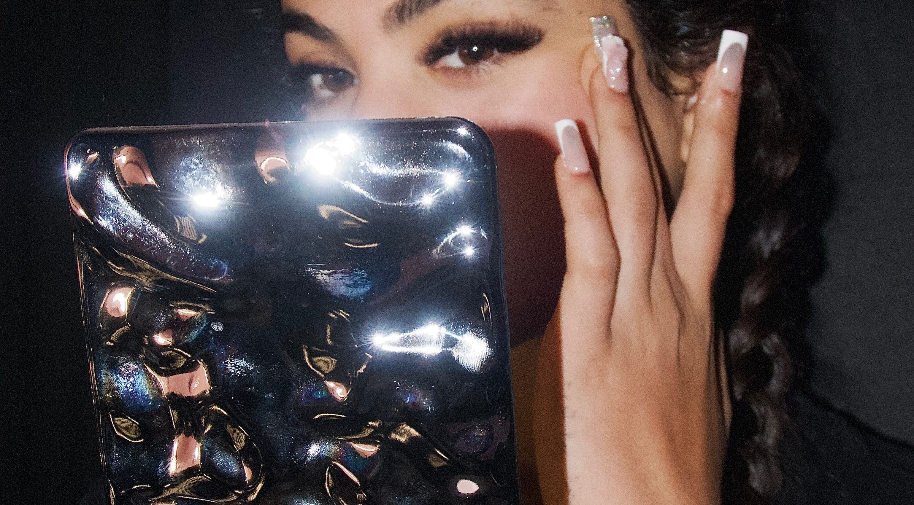 Woman with mirror and manicured nails at Ladylux de Beaute, Melbourne, Victoria, AU.