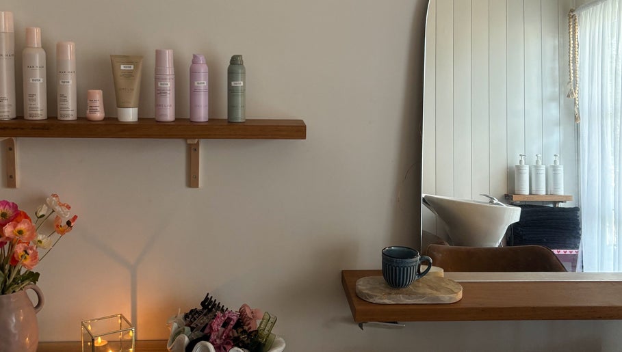 Chic styling corner at Sandy Salon, Sandy Beach, New South Wales, AU with products and a tranquil ambiance.