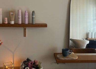 Chic styling corner at Sandy Salon, Sandy Beach, New South Wales, AU with products and a tranquil ambiance.