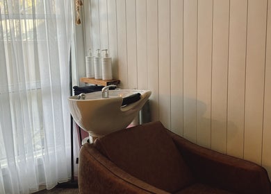 Elegant hair wash station at Sandy Salon, Sandy Beach, New South Wales, AU featuring soft lighting and cozy seating.