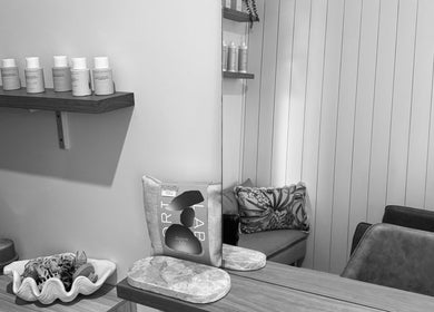 Stylish interior of Sandy Salon at Sandy Beach, New South Wales, AU featuring chic seating and product display.