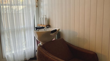 Hair wash station at Sandy Salon, Sandy Beach, New South Wales, AU with sleek basin and soft lighting.