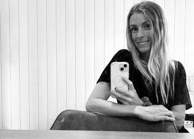 Smiling woman takes a mirror selfie at Sandy Salon, Sandy Beach, New South Wales, AU.