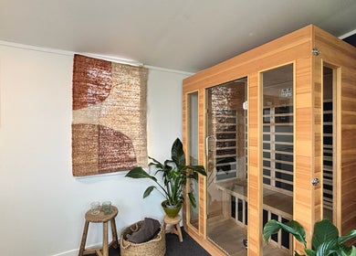 Tranquil sauna room at The Recovery Room, Auckland, Auckland, NZ, featuring wooden interior and plants.
