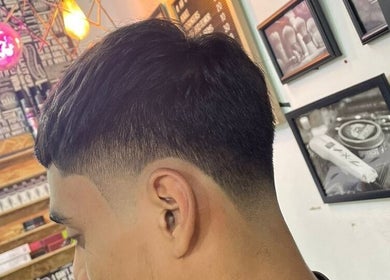 Fresh fade haircut at Pablo Barbershop, Petaling Jaya, Selangor, MY with stylish decor in background.
