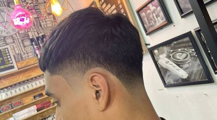 Fresh fade haircut at Pablo Barbershop, Petaling Jaya, Selangor, MY with stylish decor in background.