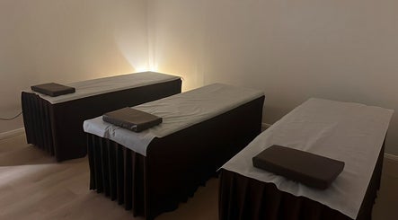 Relaxing massage room at Garden Beauty and Spa, Riverwood, New South Wales, AU featuring three serene massage tables.