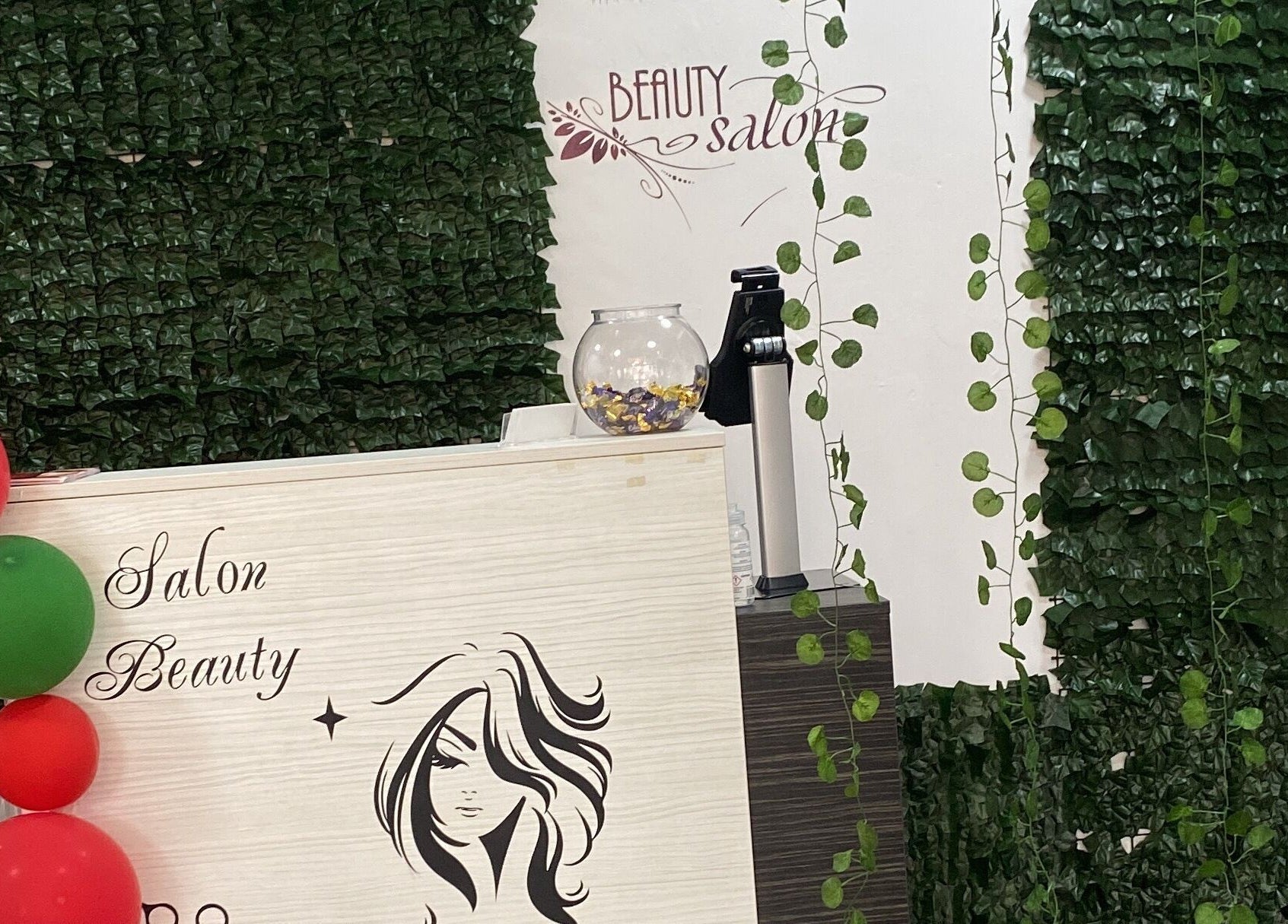 Entrance of Noks Hair and Beauty in Southend-on-sea, England with lush greenery and decorative balloons.