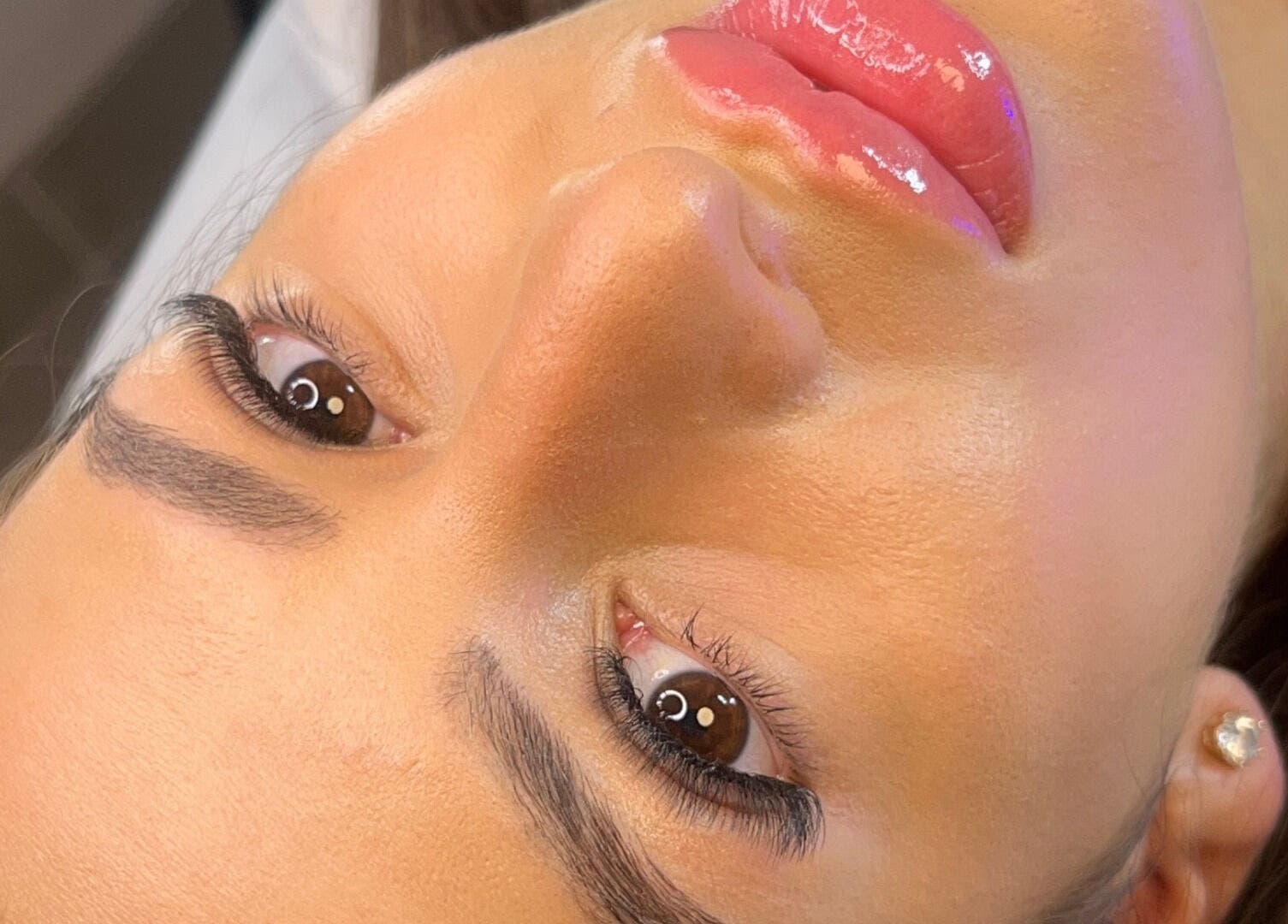 Close-up of glowing skin and glossy lips at Aiia Clinic, London, England, GB.