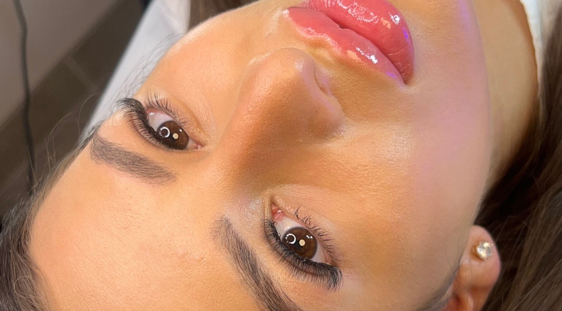 Close-up of glowing skin and glossy lips at Aiia Clinic, London, England, GB.