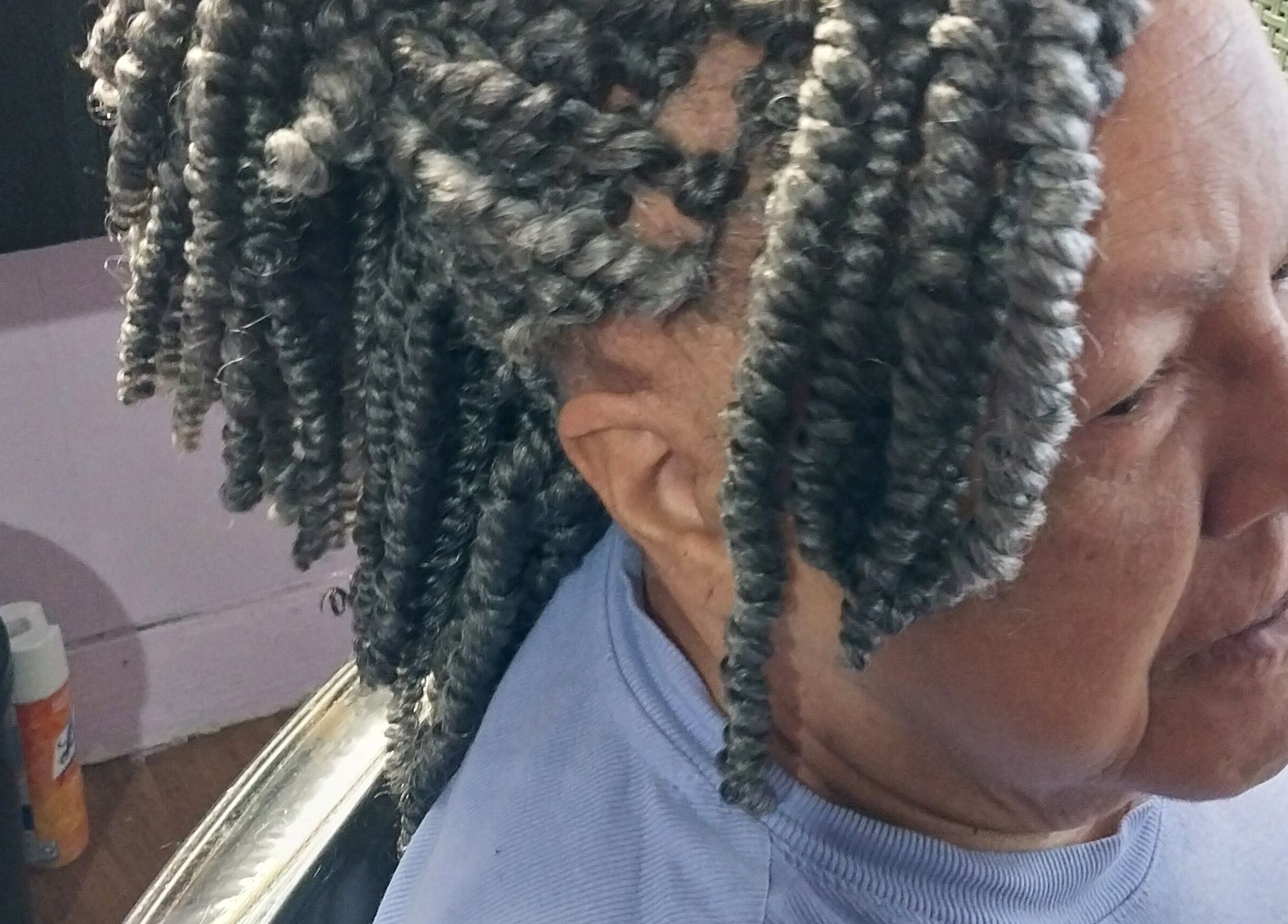 Intricate gray braids styled at Carolyn's Hair Fashion and Spa in Opelousas, Louisiana, US.