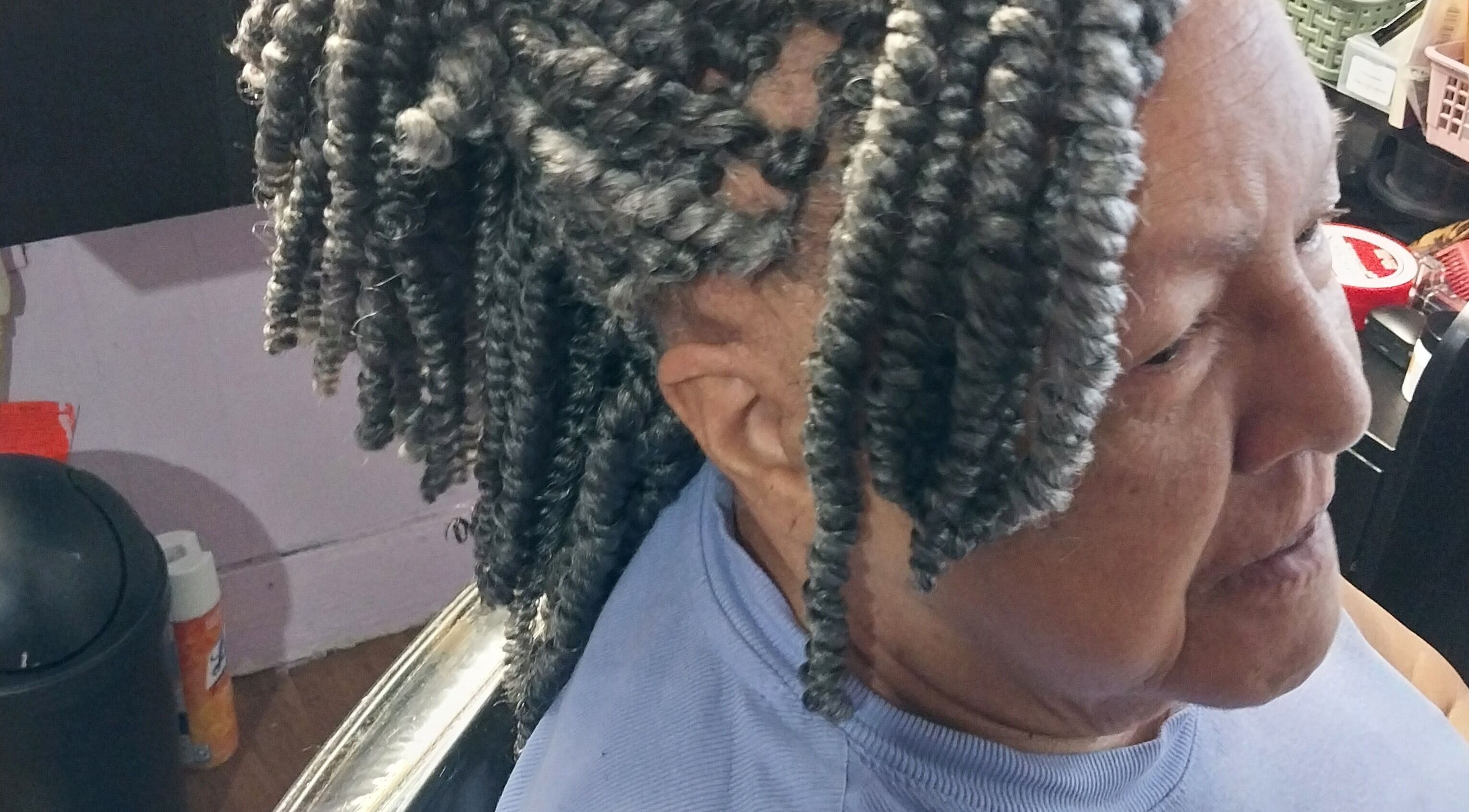 Intricate gray braids styled at Carolyn's Hair Fashion and Spa in Opelousas, Louisiana, US.