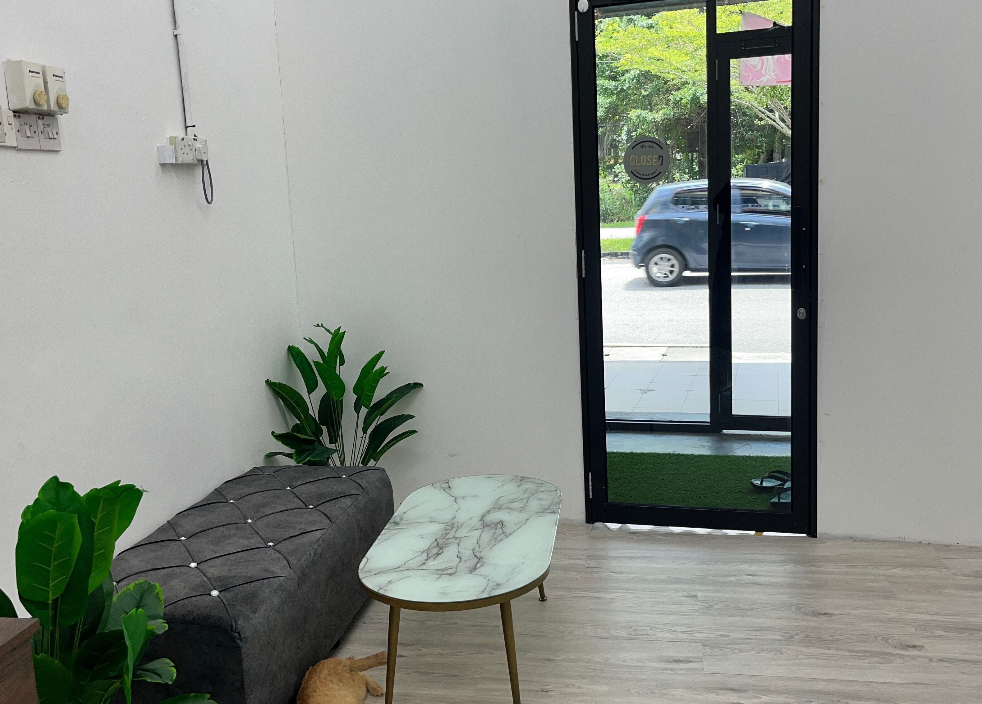 Cozy lobby with stylish decor at Beauty Bound, Sitiawan, Perak, MY, featuring plants and a marble table.