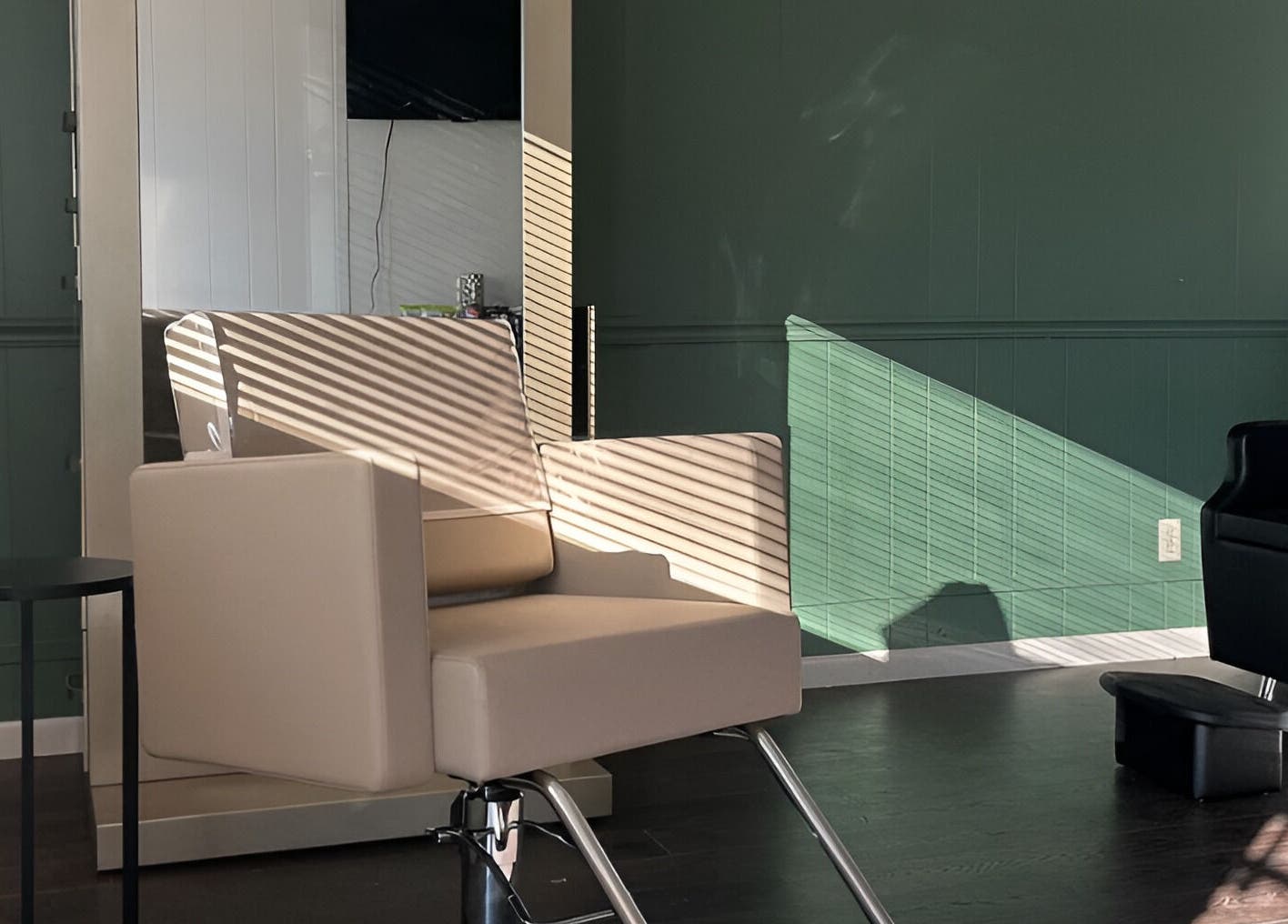 Modern salon chair in Eagle Lounge, Brookfield, Missouri, US, illuminated by soft natural light.