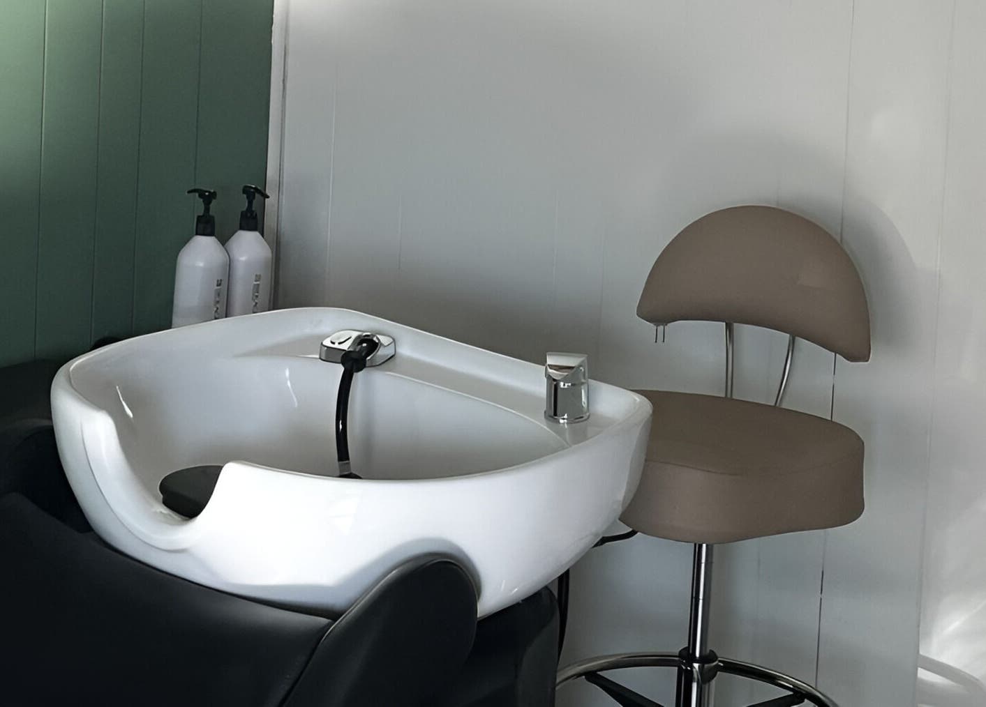 Modern salon wash station at Eagle Lounge, Brookfield, Missouri, US, featuring comfortable seating.