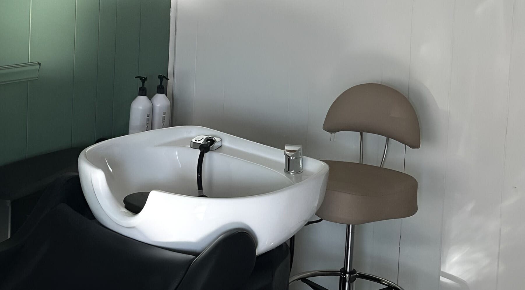 Modern salon wash station at Eagle Lounge, Brookfield, Missouri, US, featuring comfortable seating.