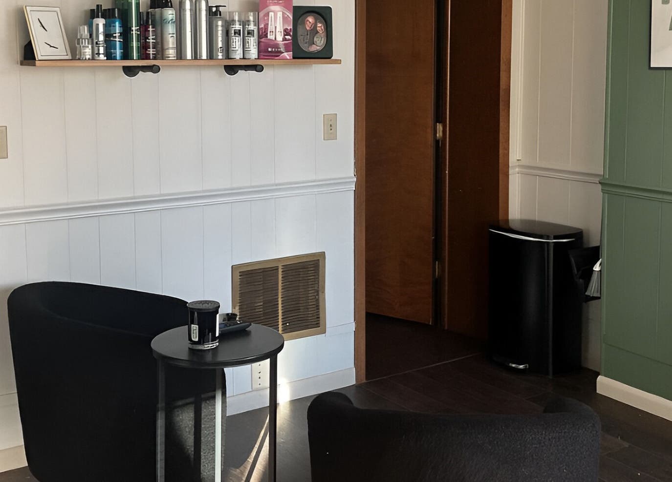 Welcome area at Eagle Lounge, Brookfield, Missouri, US with black chairs and wall shelves.