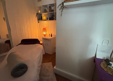 Cozy treatment room with soft lighting at Holistics by Moon Sparkles & Wood, Walkern, England, GB.
