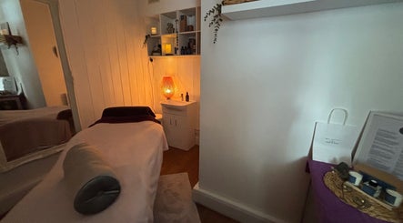 Cozy treatment room with soft lighting at Holistics by Moon Sparkles & Wood, Walkern, England, GB.