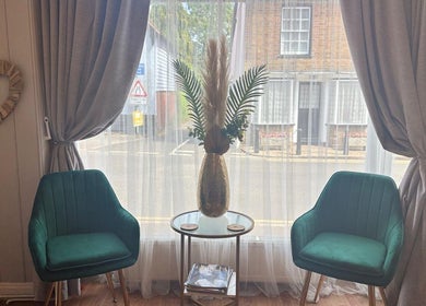 Inviting seating area at Holistics by Moon Sparkles & Wood, Walkern, England, GB, displaying two green chairs.