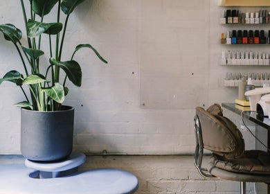 Chic nail station with lush plant at Aurum Studio LDN, London, England, GB.