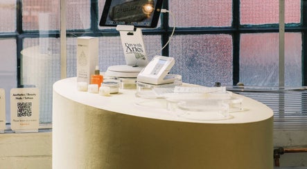 Elegant counter at Aurum Studio LDN, London, England, GB showcasing beauty products and a digital setup.