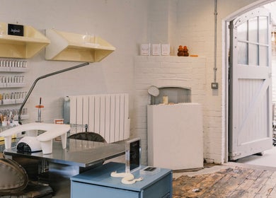 Modern nail salon interior at Aurum Studio LDN, London, England, GB showcasing elegant design and beauty products.