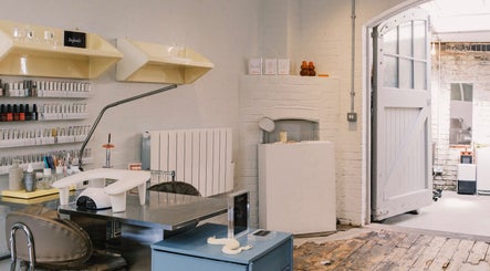 Modern nail salon interior at Aurum Studio LDN, London, England, GB showcasing elegant design and beauty products.