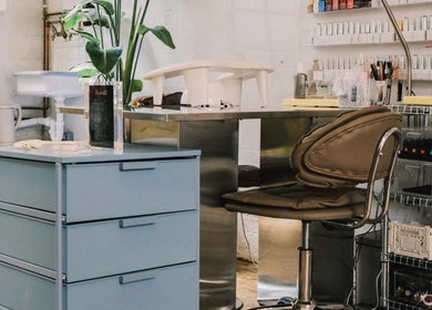 Nail station at Aurum Studio LDN in London, England, GB featuring tools and a sleek chair for clients.